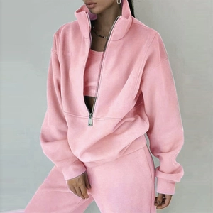 Detail of pink half-zip pullover collar with silver metal zipper and soft fleece fabric texture