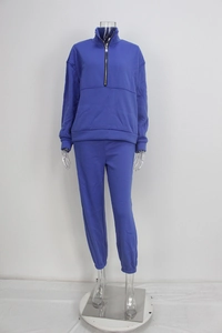 Detail of royal blue tracksuit set with half-zip stand collar and jogger pants