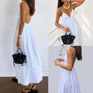 Elegant white backless maxi dress with a deep V-neckline and stylish thin straps