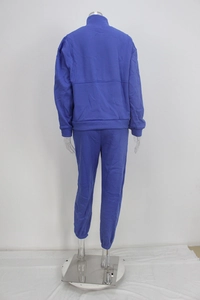 Rear view of navy blue tracksuit with half-zip stand collar jacket and cuffed jogger pants