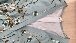 Detail of high-quality invisible zipper and floral print on light blue spring dress
