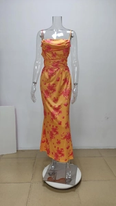Detailed view of yellow floral satin dress with cowl neck and adjustable waist tie