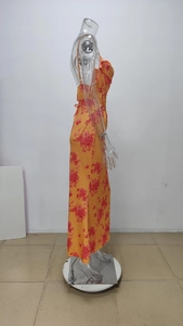 Detailed side view of a slim floral maxi dress with thin straps and orange prints