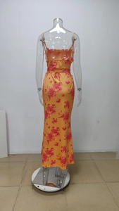 Detail view showing the adjustable waist tie on a tropical floral orange maxi dress