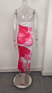 Detail view of the back slit and vibrant pink floral print on a slim tube maxi dress