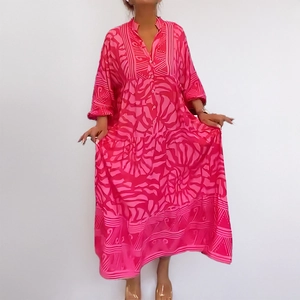 Detail of V-neck floral print maxi dress with button-up front and layered flowy skirt