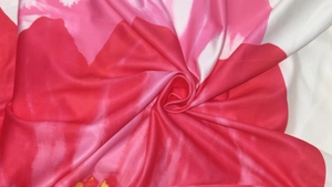 Macro detail of the elegant floral print fabric with pink and red artistic patterns