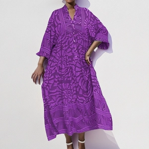 Detail of V-neckline and geometric purple prints on a long kaftan sleeve dress