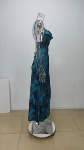 Detailed side view of abstract blue-green print dress showing draped satin fabric and waist fold