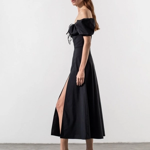 Detail of black off-shoulder midi dress with puff sleeves and high side slit