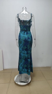 Detail of the back tie closure and vibrant floral print on the turquoise maxi dress