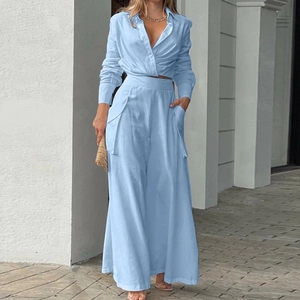Detailed view of the light blue short shirt with cross waist and wide-leg trousers