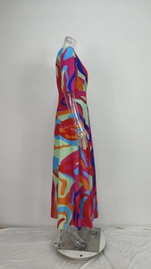 Side profile of an elegant V-neck maxi dress featuring a vibrant abstract swirl print
