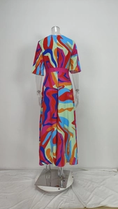 Back view detail of an elegant v-neck printed slim maxi dress on a clear mannequin.