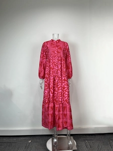 Detail of red and pink geometric print on a V-neck maxi dress with tiered skirt