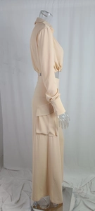 Detail view of light beige two-piece set with cropped shirt and cargo maxi skirt
