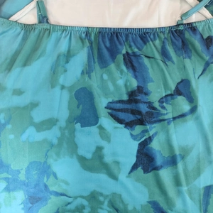 Detail of teal floral print neckline with fine pleats and adjustable spaghetti straps