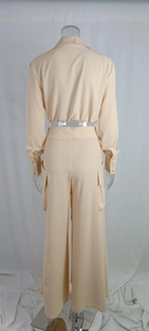 Detail view of high-waist wide-leg trousers with back zipper and utility cargo pockets