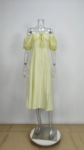 Detailed view of pale yellow off-shoulder dress featuring puff sleeves and a side slit