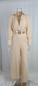 Detail view of the cropped long sleeve shirt with twisted knot design and high waist pants