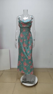 Close-up of mint green satin maxi dress featuring pink floral patterns and cowl neck