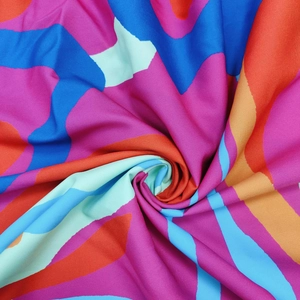 Macro shot of colorful geometric wave print fabric showing detailed woven material texture