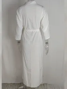 Detail view of a white long-sleeved high waist tie dress available in sizes S to 3XL
