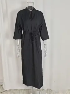 Detail of elegant black high-waist maxi dress with a V-neck and a waist-tie design
