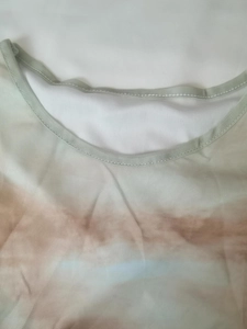 Detailed macro view of the crew neckline and soft mesh fabric with colorful print