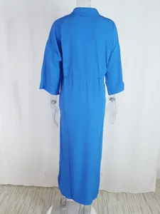 Detail view of high-waist tied maxi dress with elastic waist and solid blue fabric
