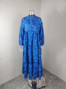 Detailed view of bohemian blue floral maxi dress with tiered skirt and V-neckline buttons