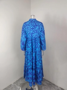 Rear view of long sleeve tiered maxi dress with blue tribal print and elastic waist