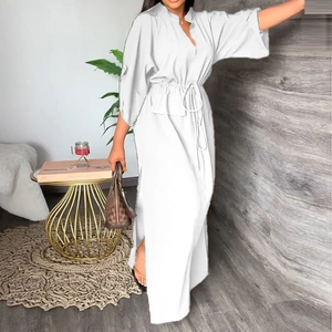 Detail of white V-neck maxi dress featuring adjustable drawstring waist and side slit detail