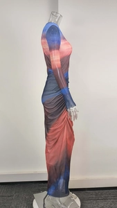 Detail view of sunset gradient mesh fabric and side rushing on a slim long sleeve dress