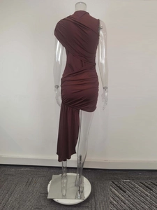 Detail of burgundy ruched halter dress featuring an asymmetrical hem and silky fabric texture