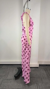 Detail view of pink polka dot maxi dress with elegant ruched sides and halter neckline