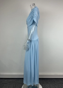 Close-up of side pleats and high waist detail on light blue long dress
