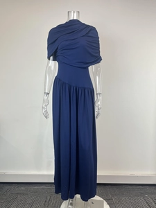 Detail view of navy blue maxi dress with elegant asymmetrical pleats and high neckline