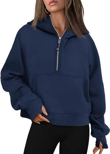 Detail showing navy blue hoodie with thumbholes sleeves and a kangaroo pocket design