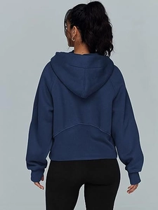 Rear view of cropped navy blue half-zip hoodie with dropped shoulders and large hood