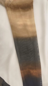 Close-up of semi-transparent gradient mesh fabric detail on elegant slim fit dress