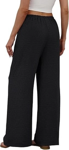 Detail view of black wide-leg pants featuring textured crepe fabric and elastic waistband