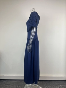 Detail view of ruched shoulders and sleeve design on a navy blue fitted maxi dress