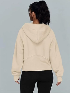 Rear view of a beige half-zip hoodie with arched back seam and soft fleece fabric