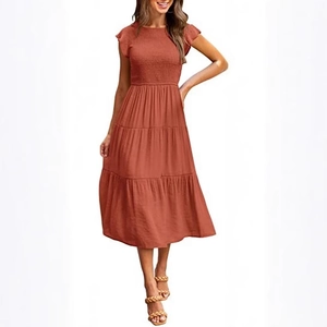 Women's rust red tiered smocked dress with flutter sleeves and a flowy layered skirt