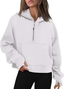 Detail of white half-zip hoodie with thumbholes and metal circular zipper puller