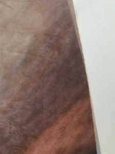 Close-up detail of the brown gradient mesh fabric with a fine mesh structure