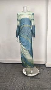 Detail view of sheer mesh fabric with blue-green tie-dye pattern and side waist ruching