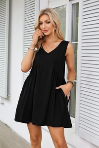 Detail of V-neck sleeveless dress featuring functional pockets and soft pleats
