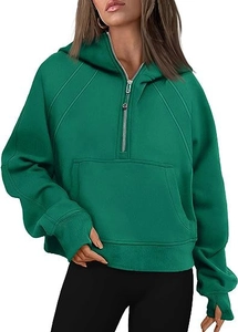 Close-up of green half-zip hoodie featuring thumbholes and detailed kangaroo pocket